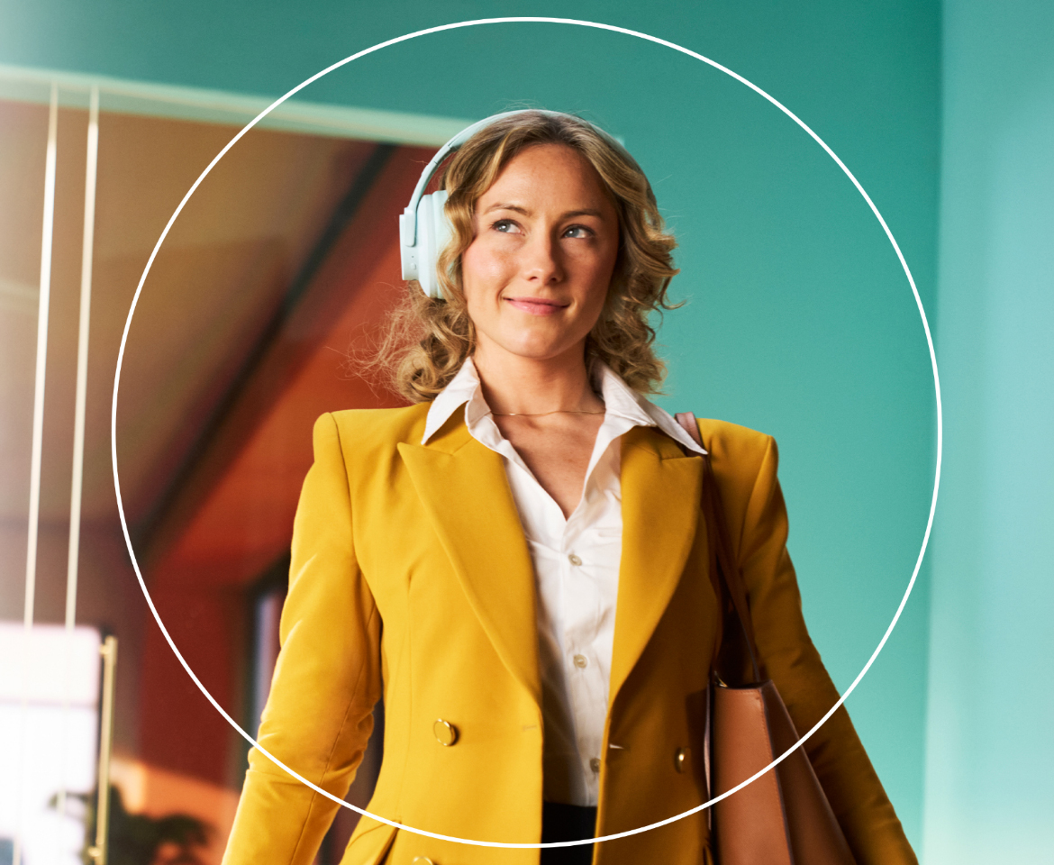 Woman outside holding a camera and looking off into the distance with a white circle around her.