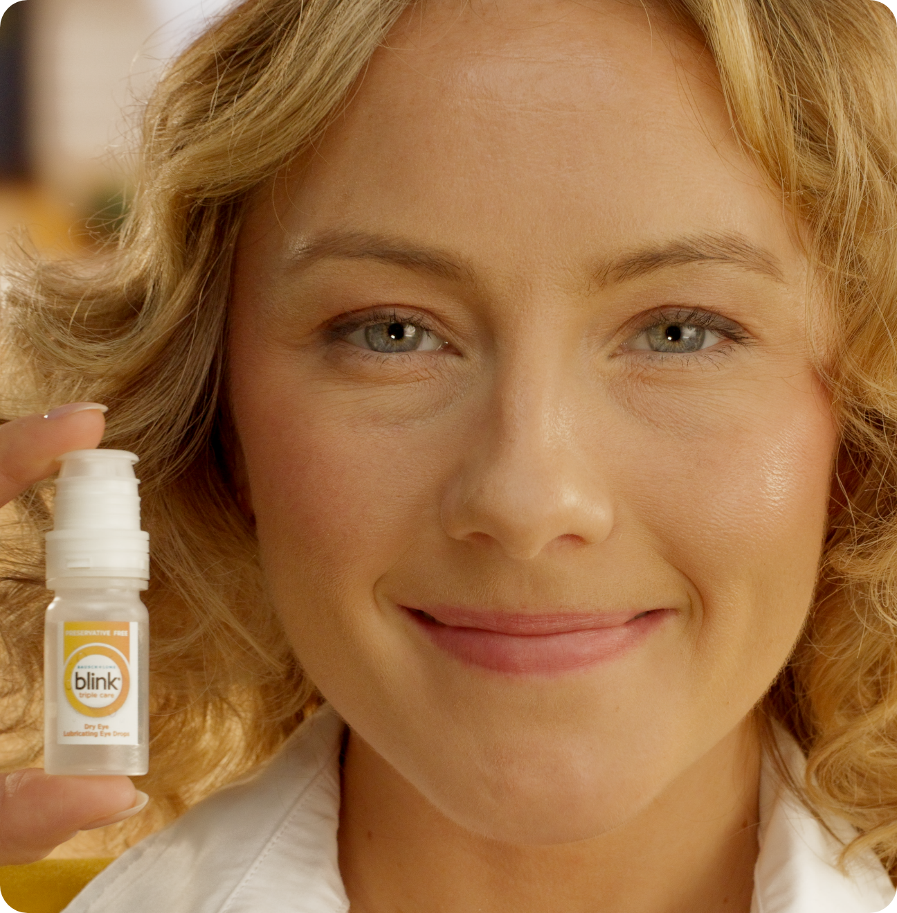Man putting a drop of Blink Triple Care in his eye